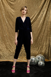 Soft velvet wrap blouse with 3/4 sleeves and gathered waist for a sleek feminine silhouette